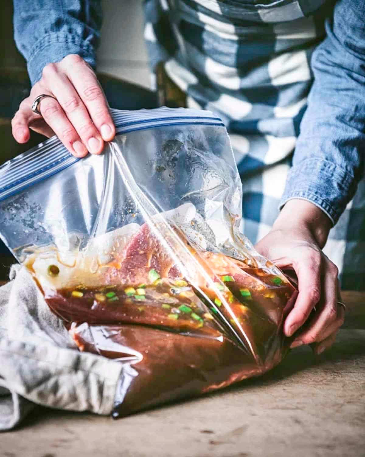 flank steak marinating in a ziplock bag