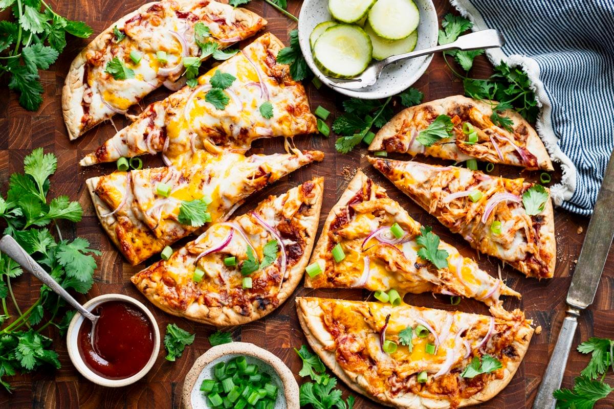 Overhead shot of BBQ chicken flatbread being prepared on a griddle