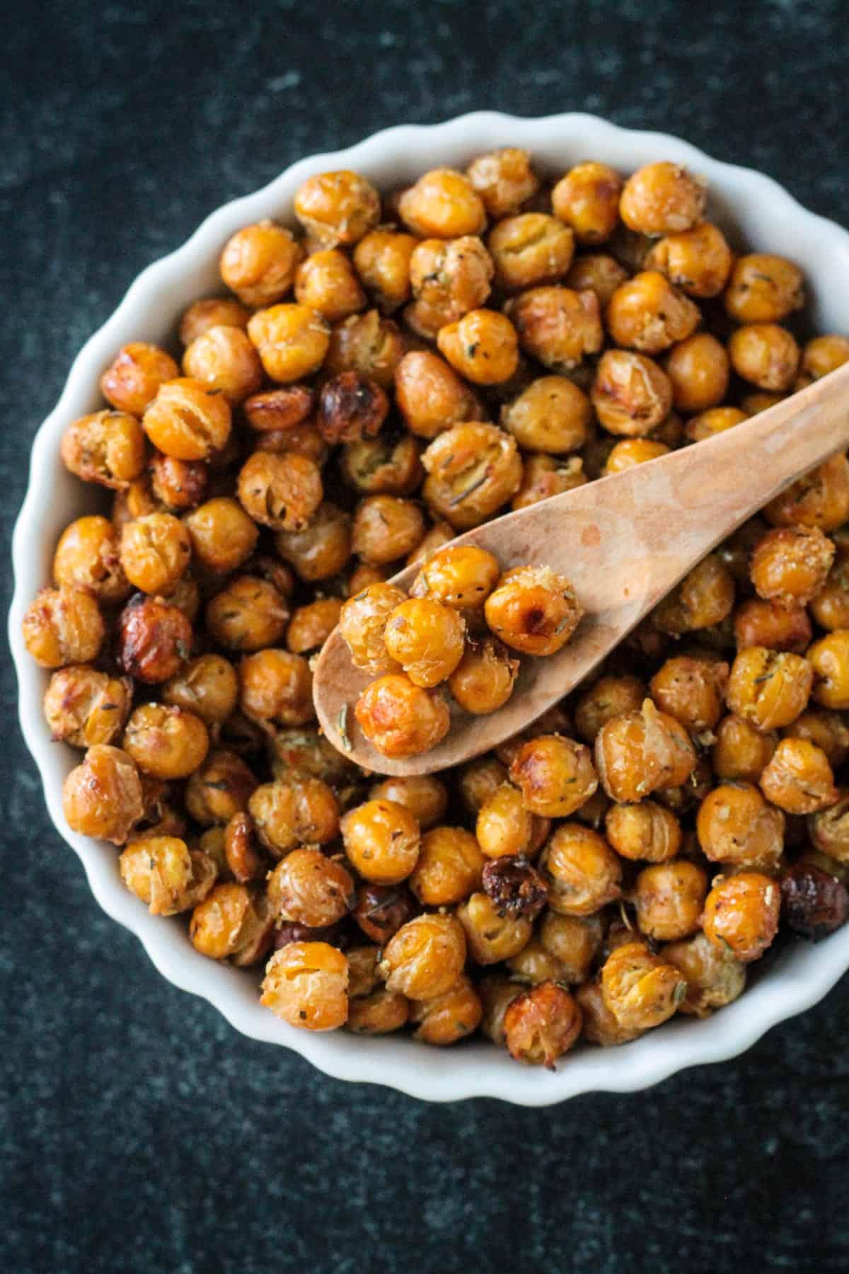 Close-up shot of a chickpea being tossed with spices