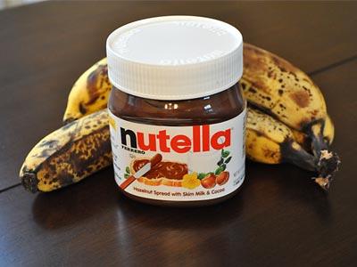 Close-up shot of ripe bananas and a jar of Nutella