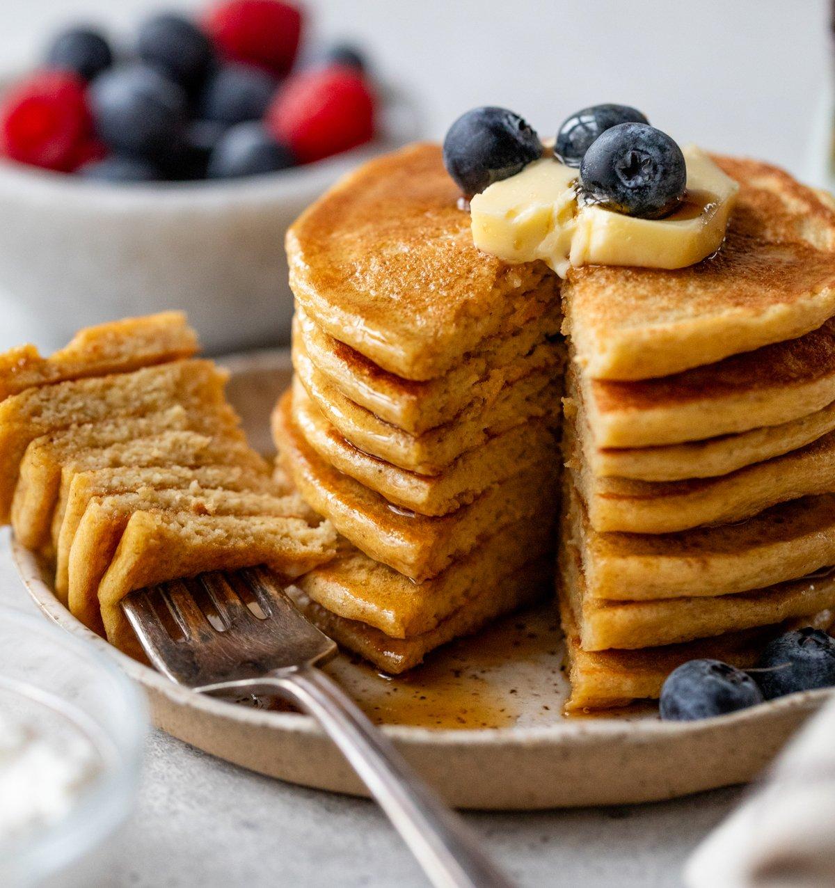 stack of cherry almond cottage cheese protein pancakes with syrup