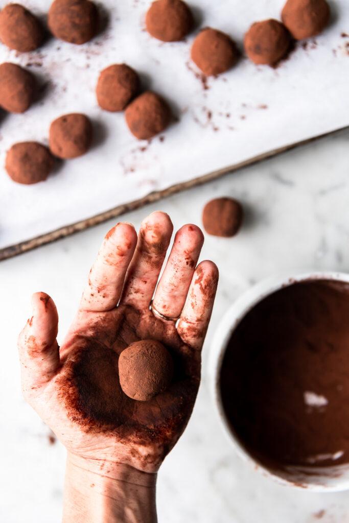 hand reaching for a spicy chocolate truffle