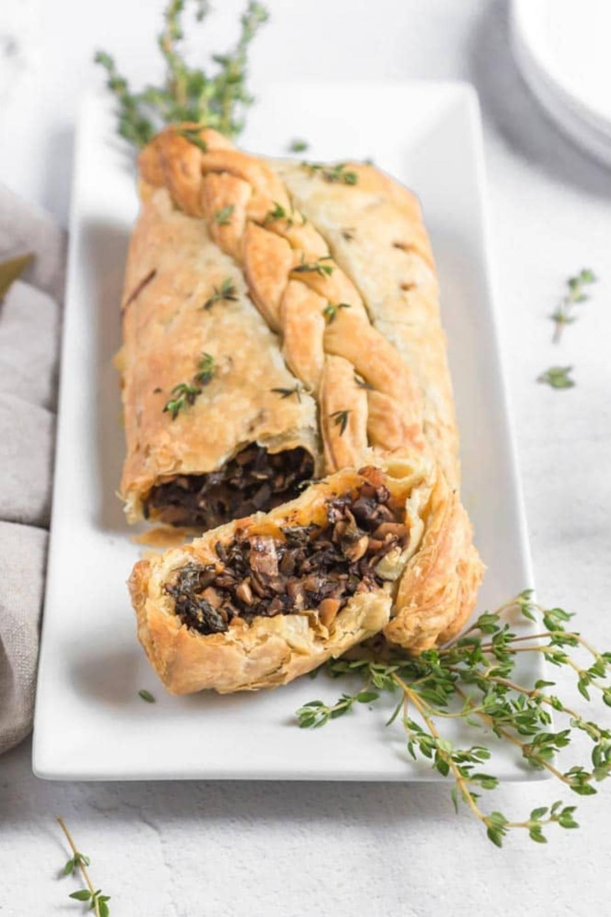 Finished Mushroom Wellington stuffed peppers, sliced open to reveal the filling