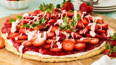 Overhead shot of Strawberry Shortcake Pizza with Mascarpone, vibrant and colorful, displayed on a wooden pizza board