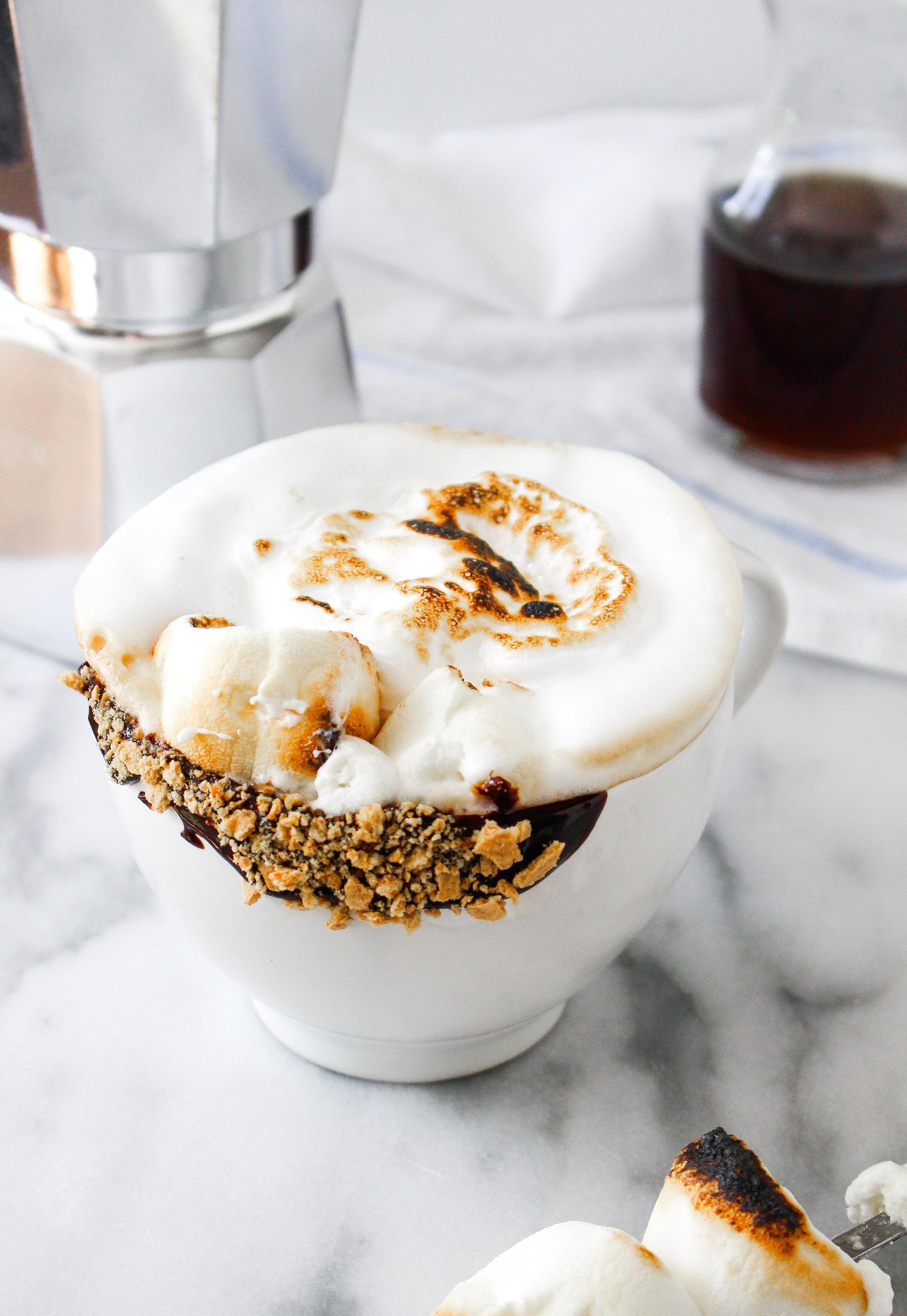 overhead shot of a person holding a Toasted Marshmallow Chai Fluff Latte