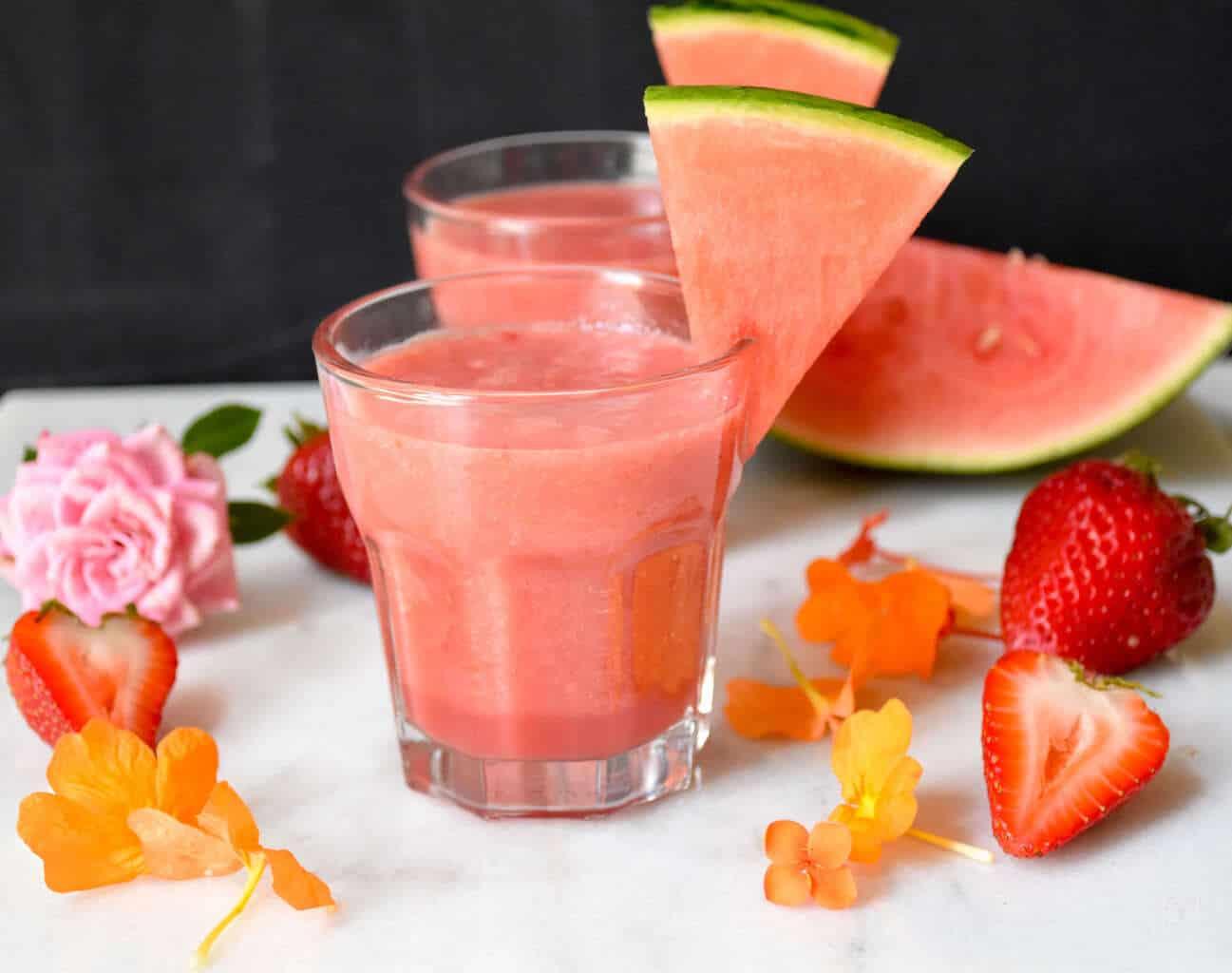 child helping to make a watermelon strawberry banana smoothie