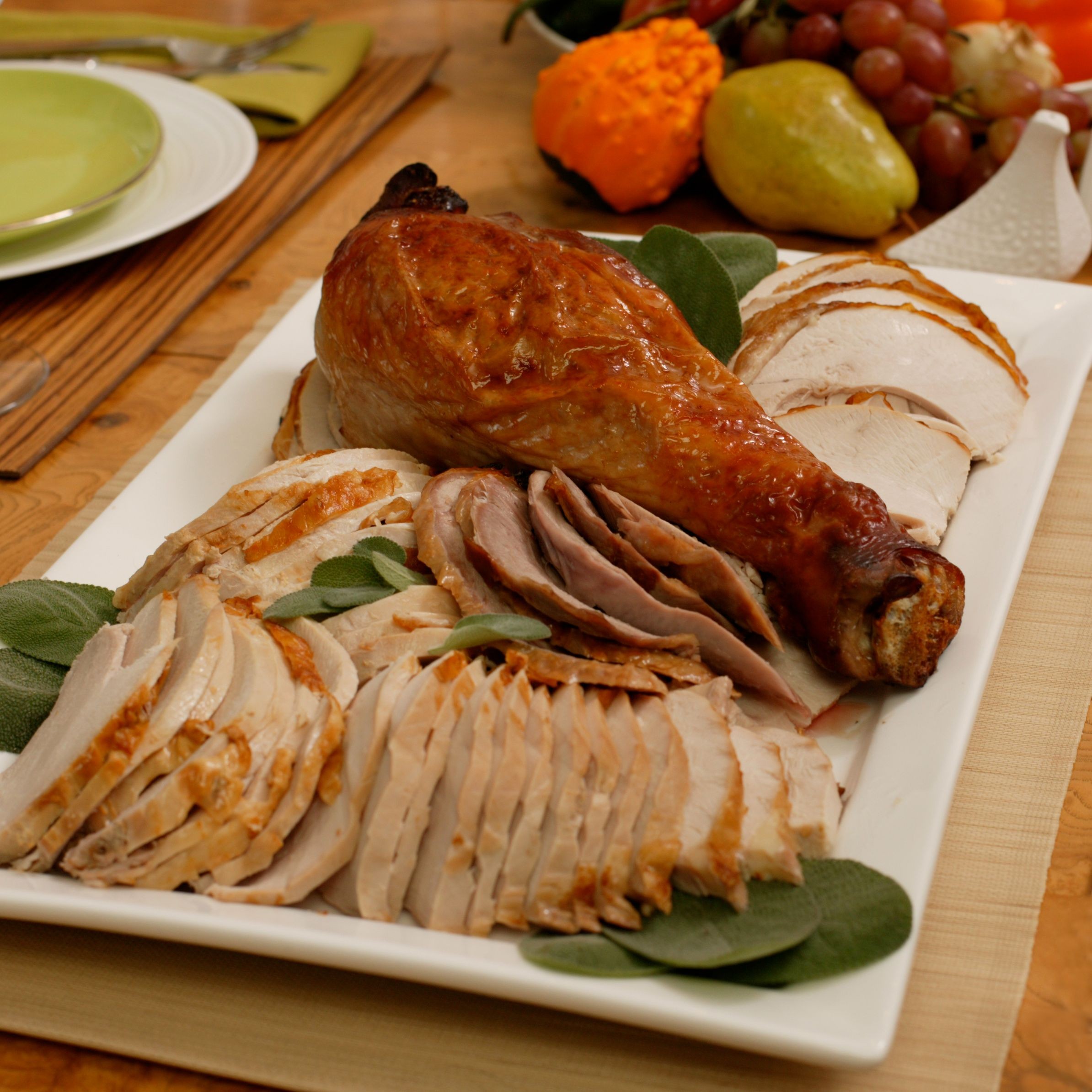 Whole roasted sage butter turkey with rich pan gravy on a festive table, close up