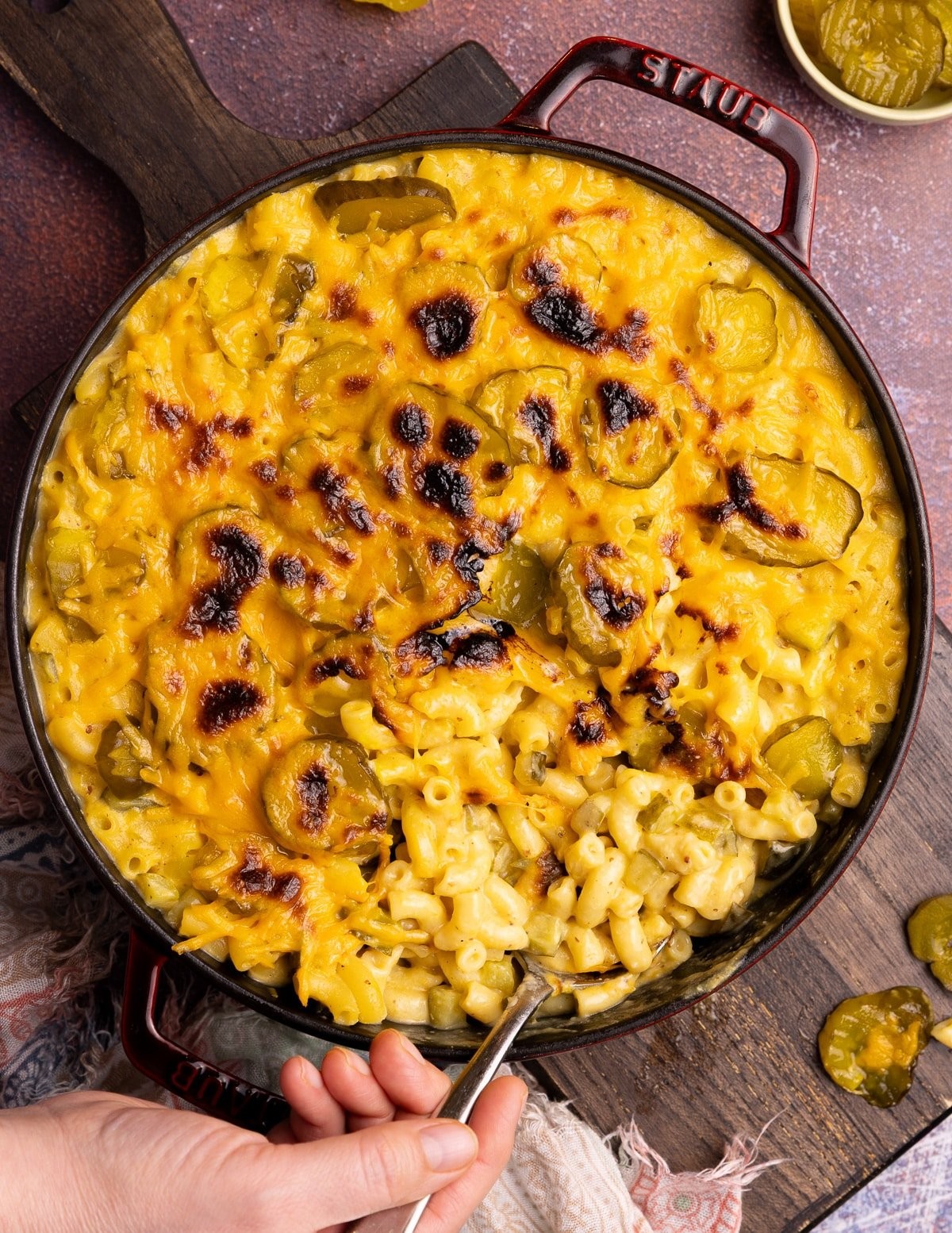 vegan mac and cheese with dill pickles on top, close-up shot