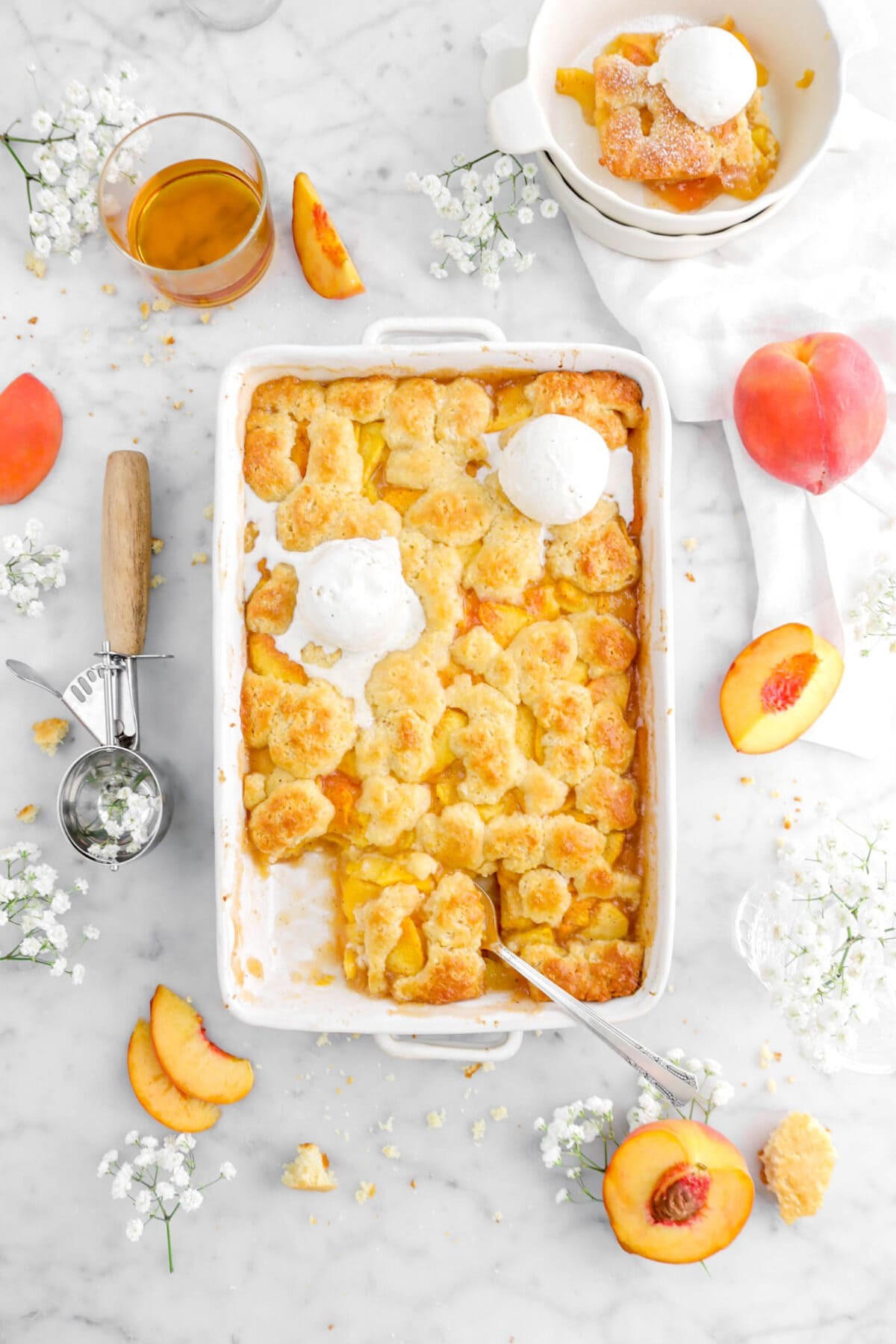 golden peach cobbler with tuberose flowers around it
