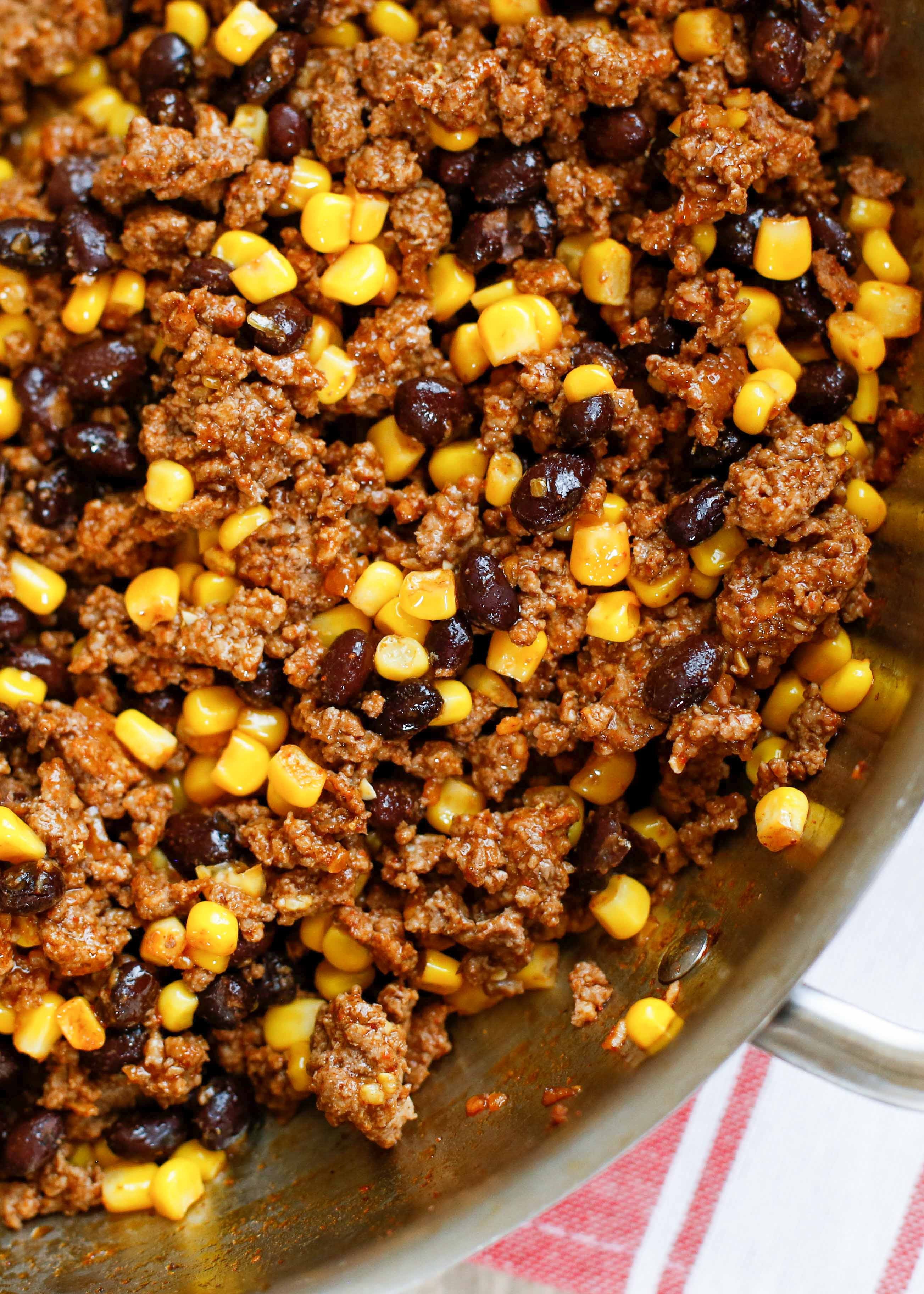 close up of delicious black bean corn ground beef tacos with fresh toppings