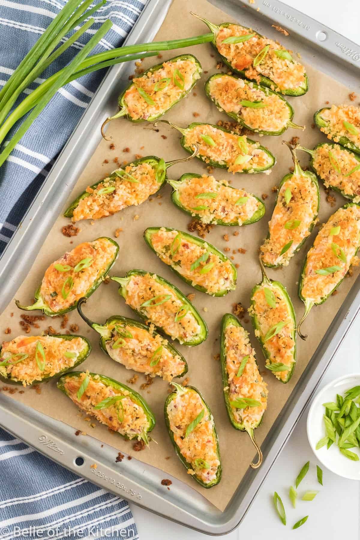 Jalapeño Cheddar Stuffed Peppers on a baking sheet