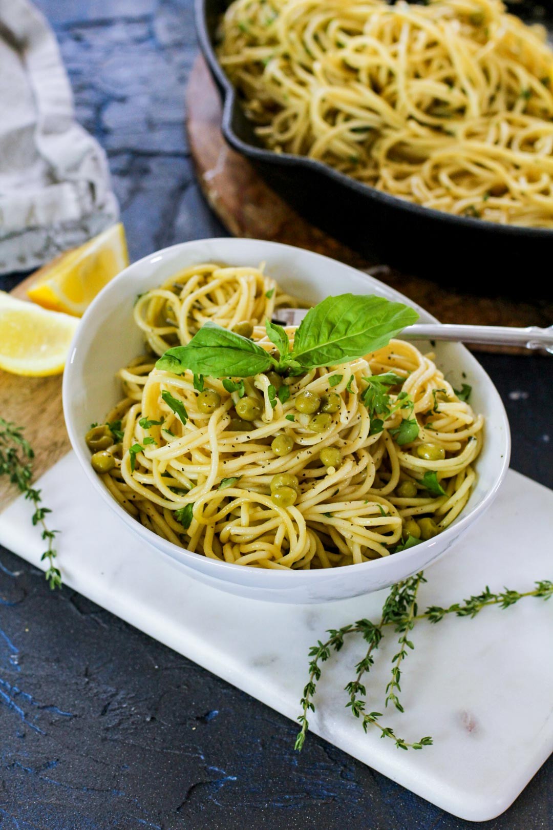 A vibrant bowl of garlic herb pasta, steam rising, garnished with fresh parsley and Parmesan.