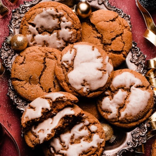 plate of dark molasses cookies with powdered sugar, warm lighting, cozy kitchen background