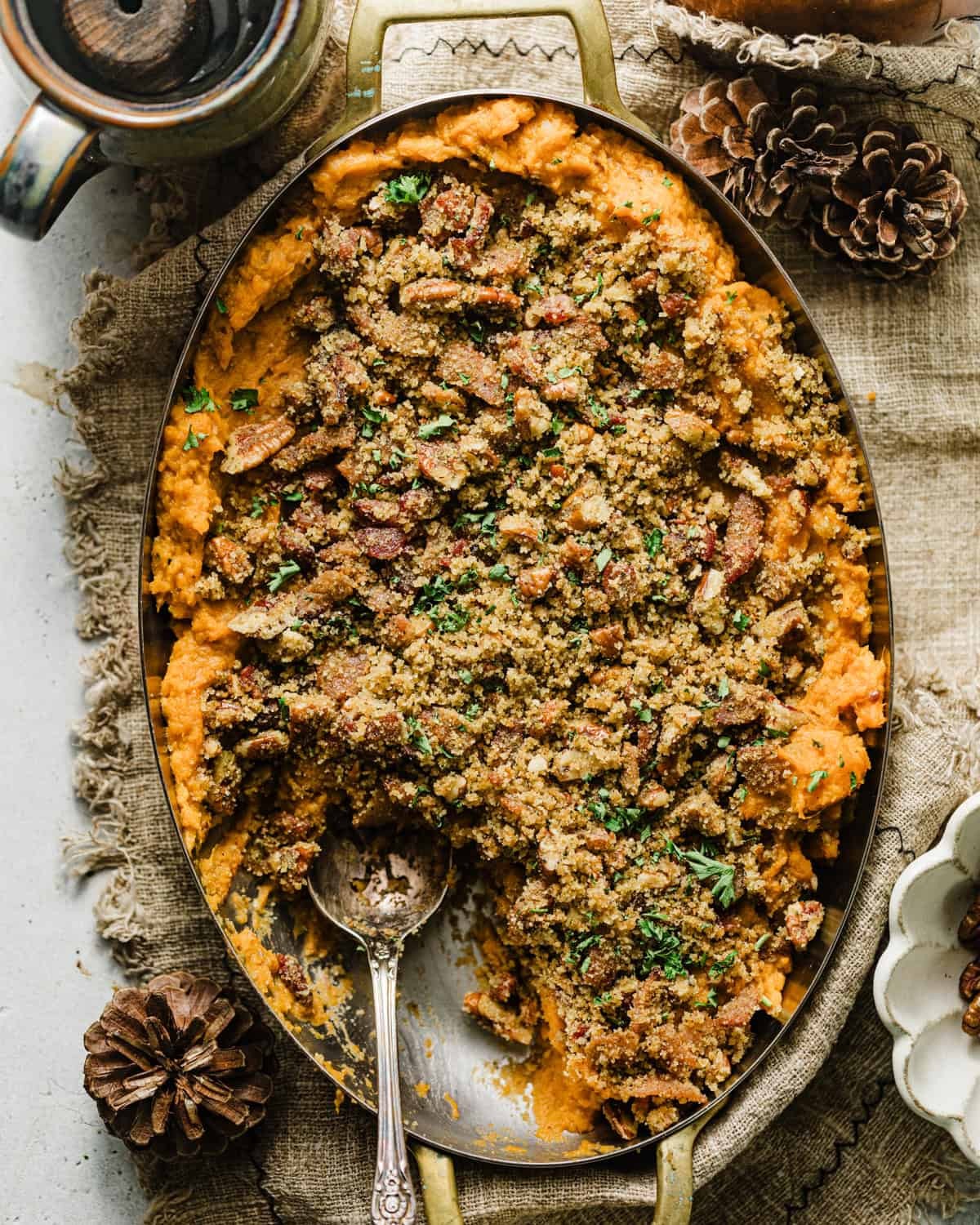 savory sweet potato casserole with fresh herbs on top, golden brown