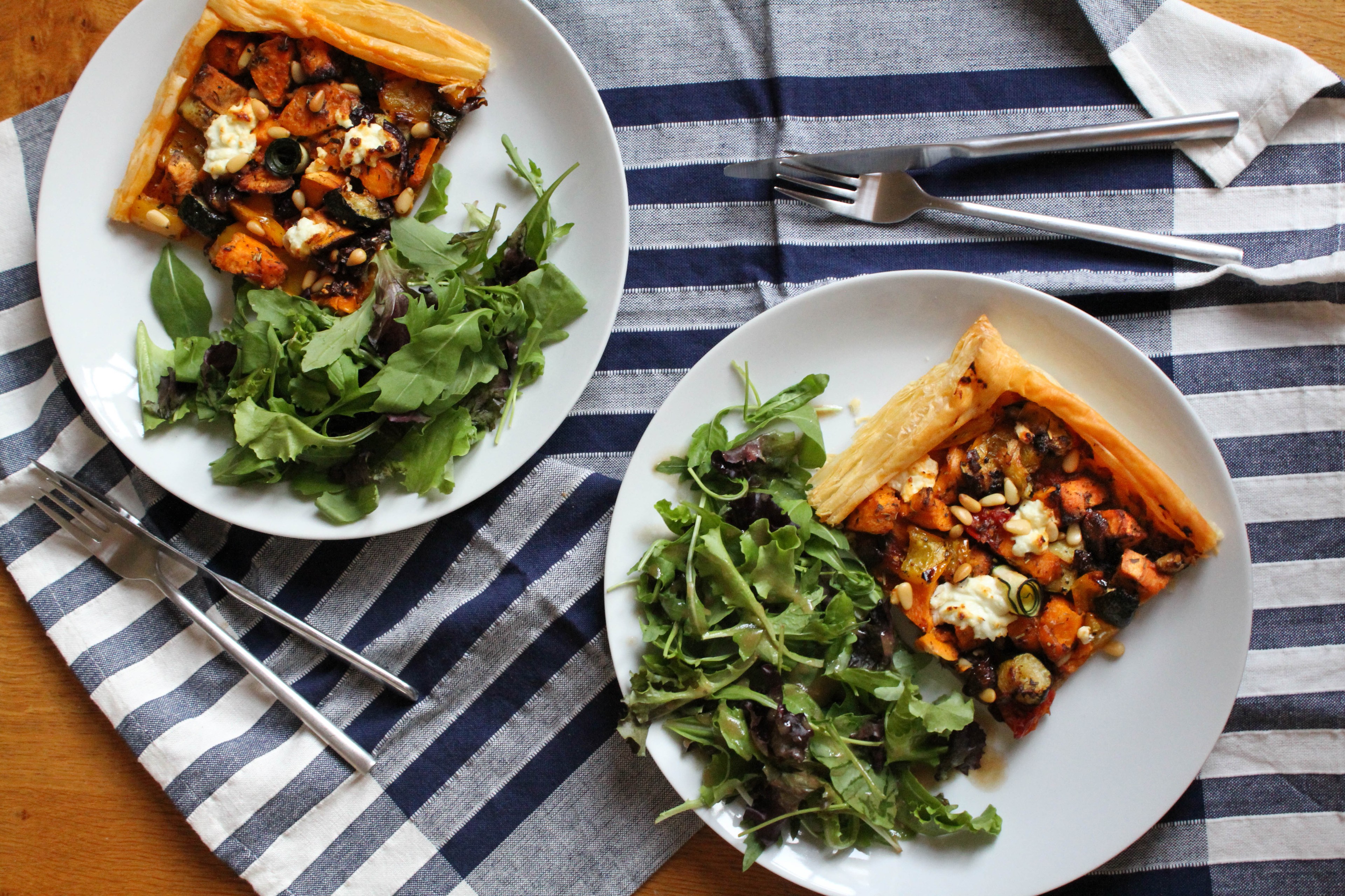 roasted vegetables and goat cheese tart on a wooden board