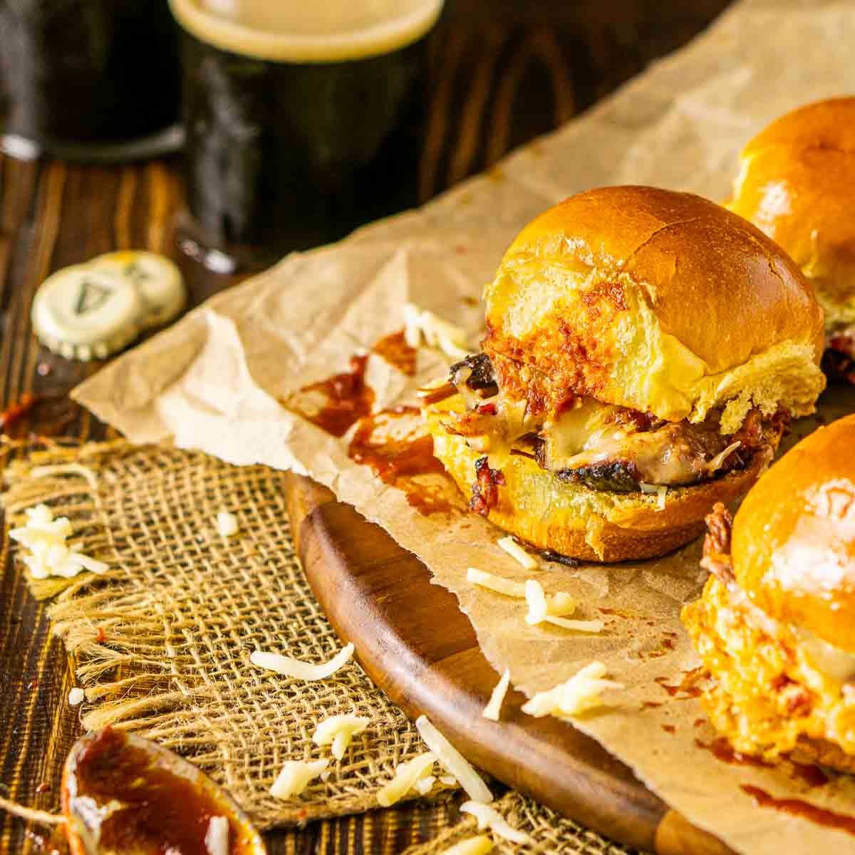 fennel orange bbq brisket sliders on a wooden board