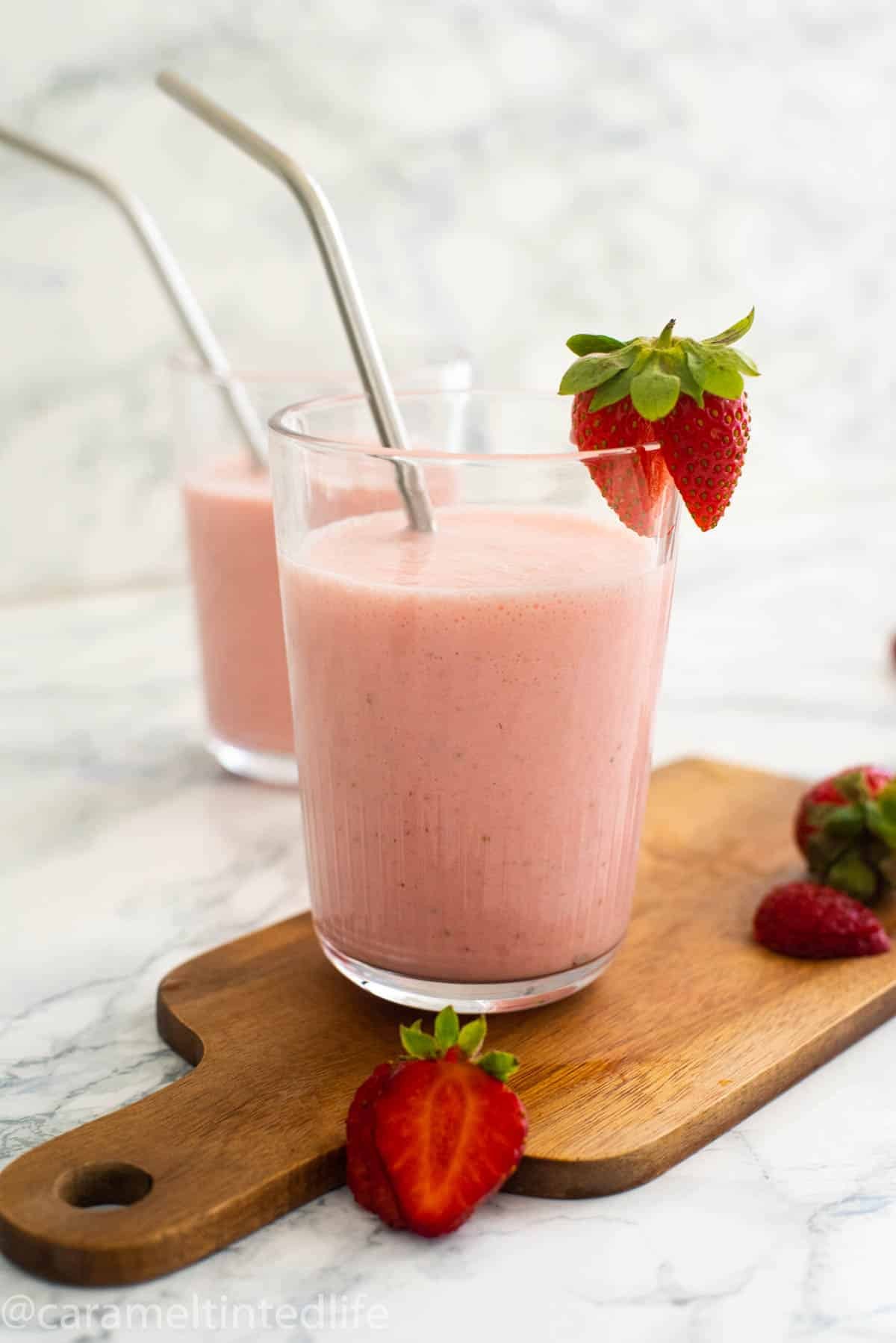 vibrant strawberry sunrise lassi in a glass