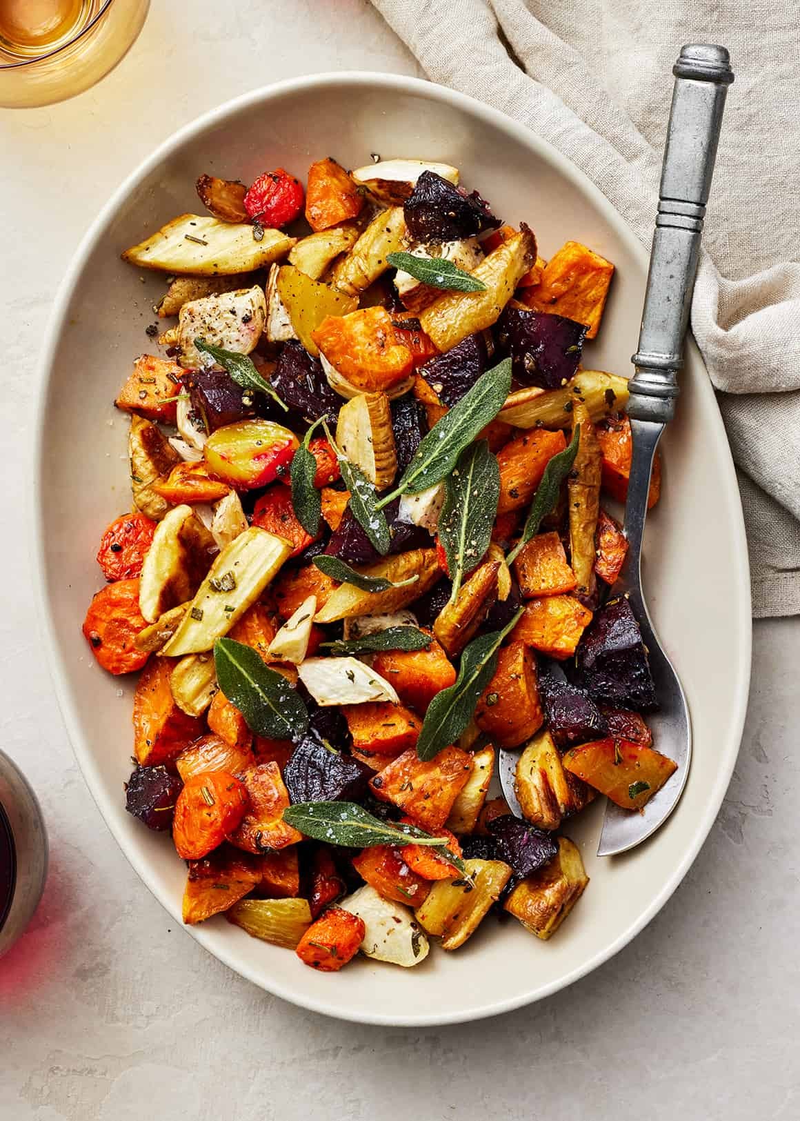 vibrant roasted root vegetables with fresh herb oil drizzle, rustic wooden background