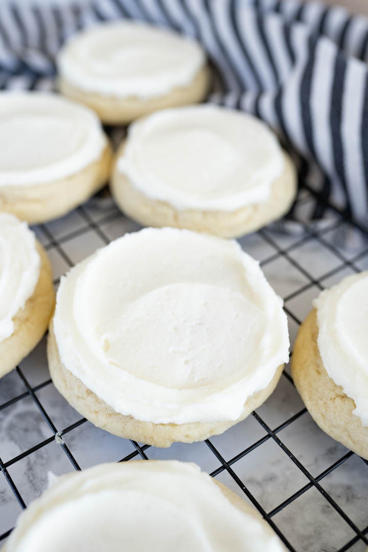 Close-up, inviting image of vanilla crumb sugar cookies on a cooling rack, sunlight, cozy feel.