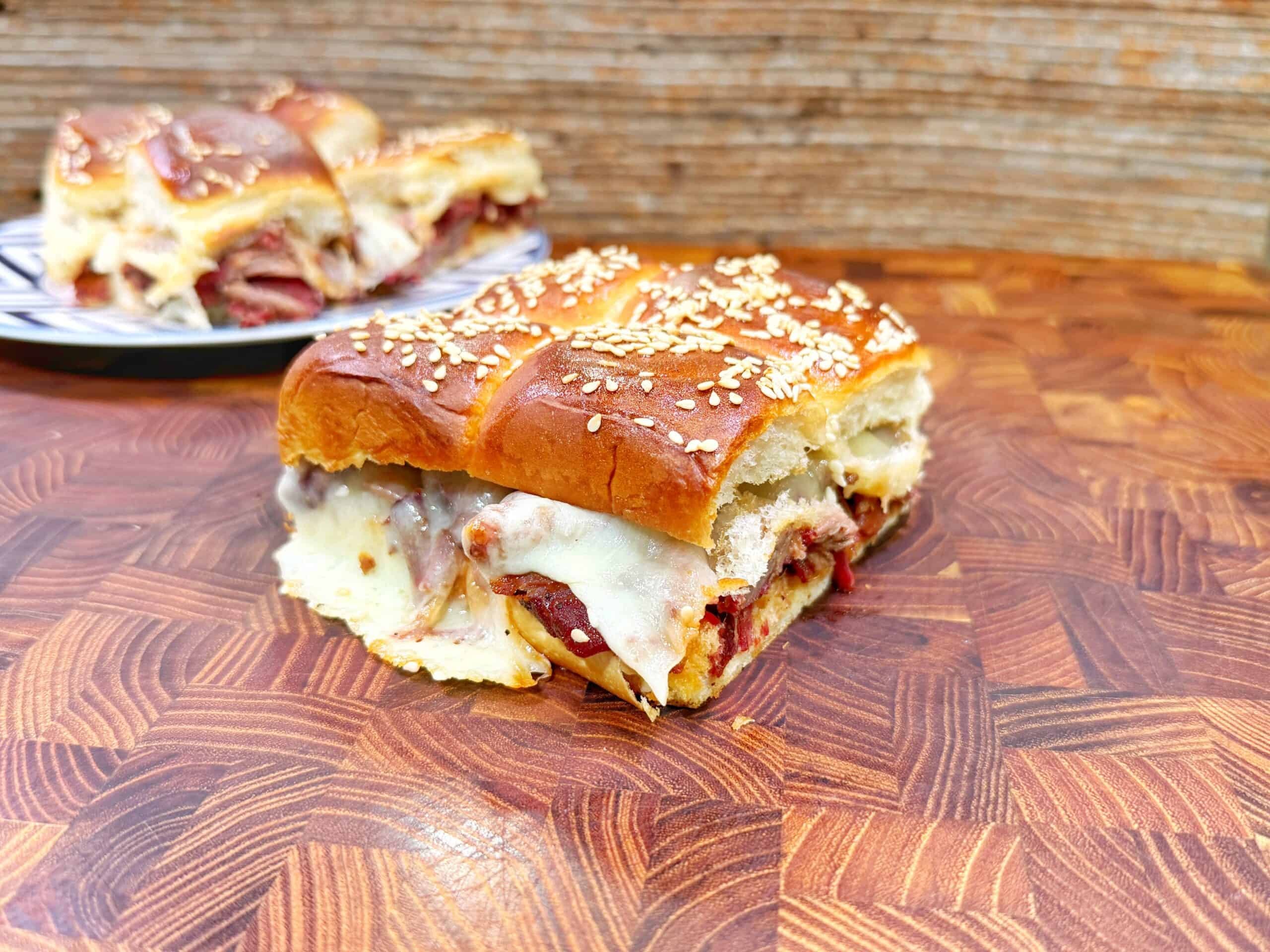 close up quince paste bbq beef sliders with melted manchego cheese