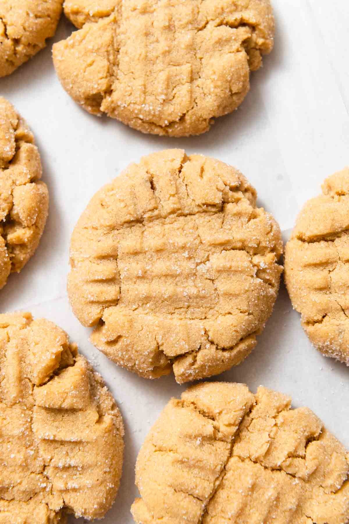 freshly baked peanut butter cookies with perfect crisscross marks on a vintage cooling rack, sunlight, cozy kitchen