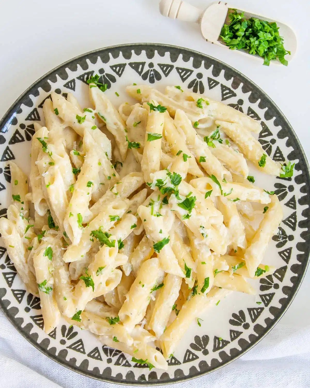 vibrant close-up of creamy parmesan pasta in a single pot, steaming, garnished with fresh herbs