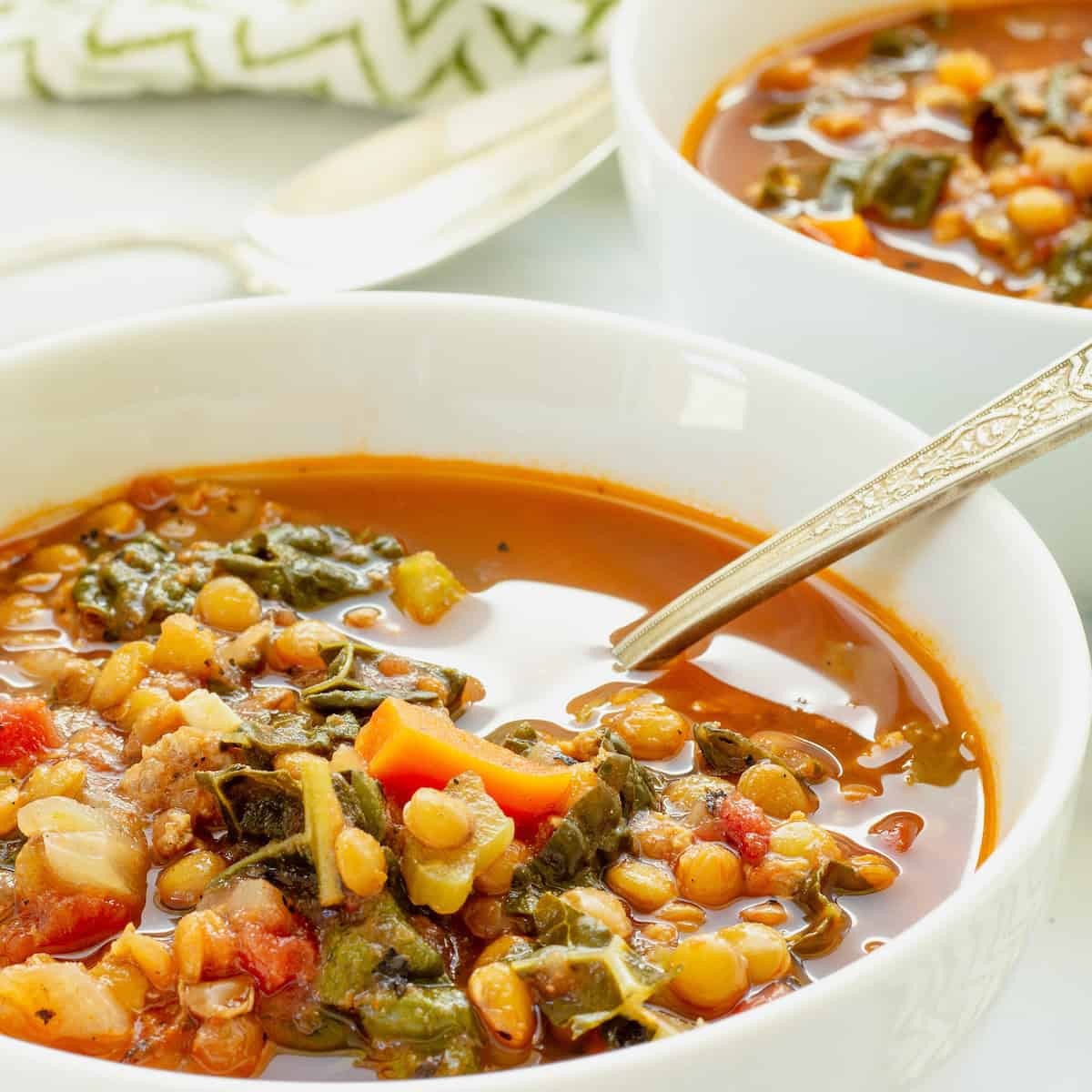bowl of lentil and vegetable soup with sausage