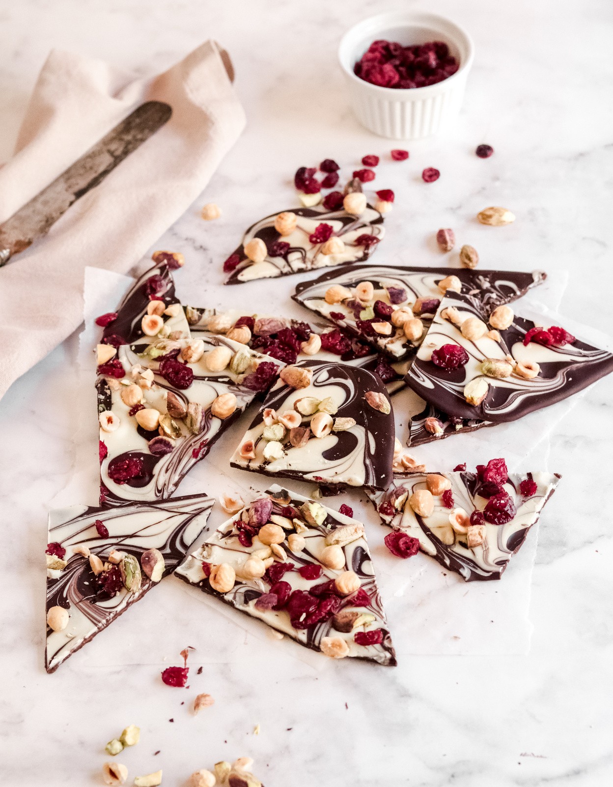 Vibrant swirled chocolate bark with pistachios and dried cranberries, top view