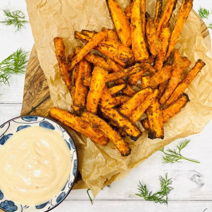 carrot fries served with black bean dip on a wooden board