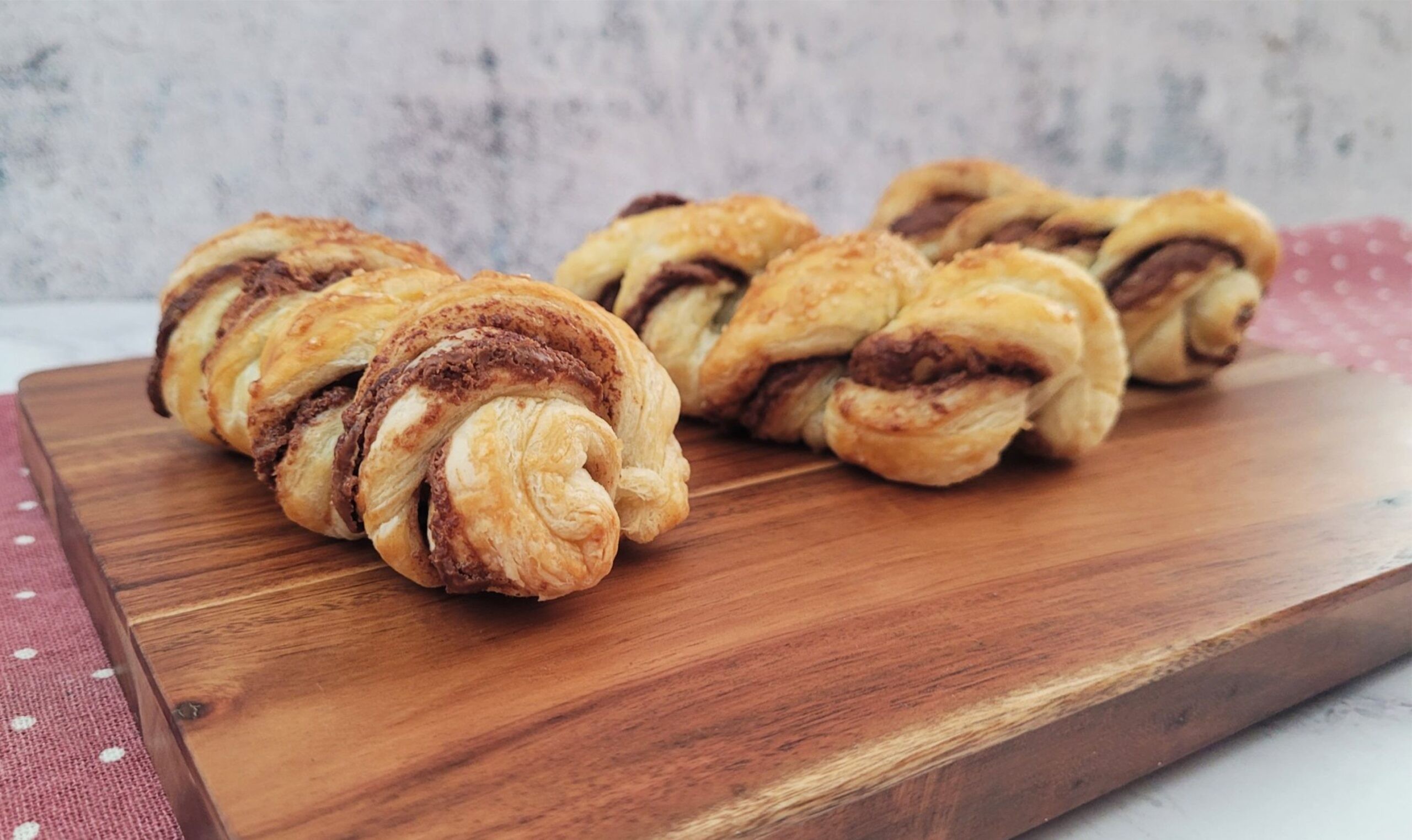 Nutella swirled hazelnut cookies on a wooden board