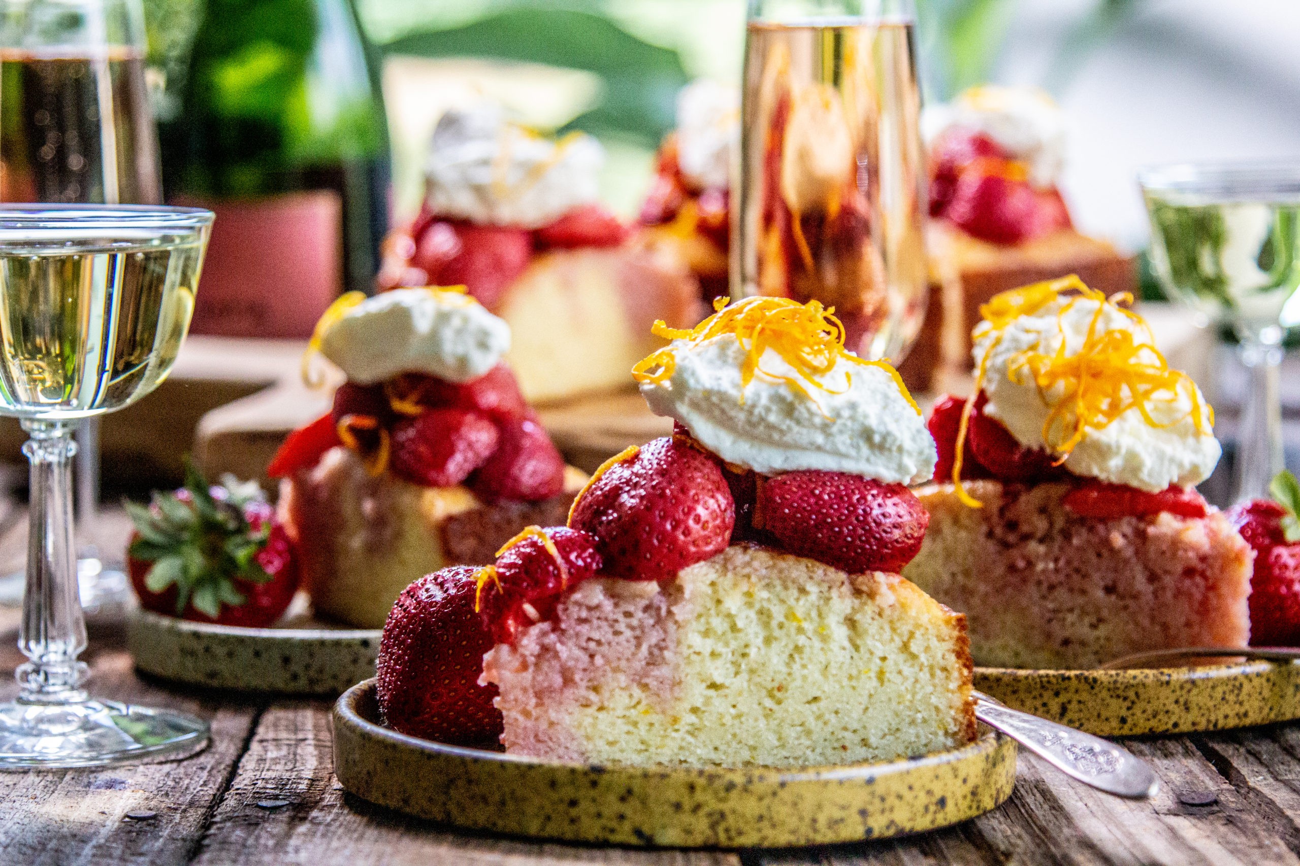 orange blossom strawberry shortcakes on a rustic wooden table