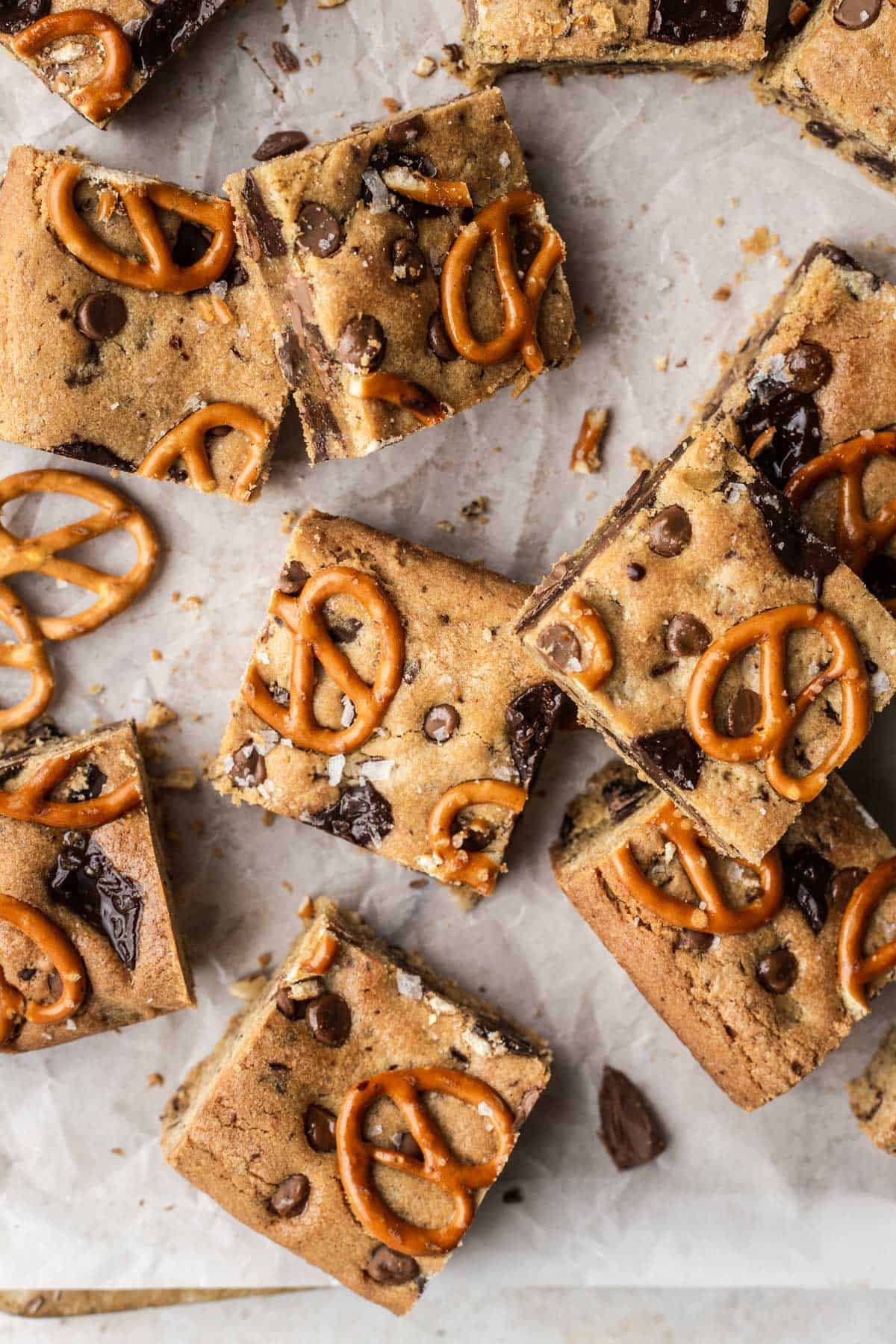 Rhubarb peanut butter chocolate bars on a wooden surface, cut into squares