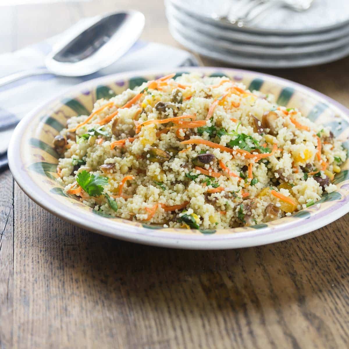couscous salad with apricots and almonds served on a white platter