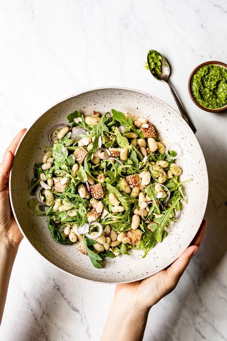 white bean arugula salad in a bowl