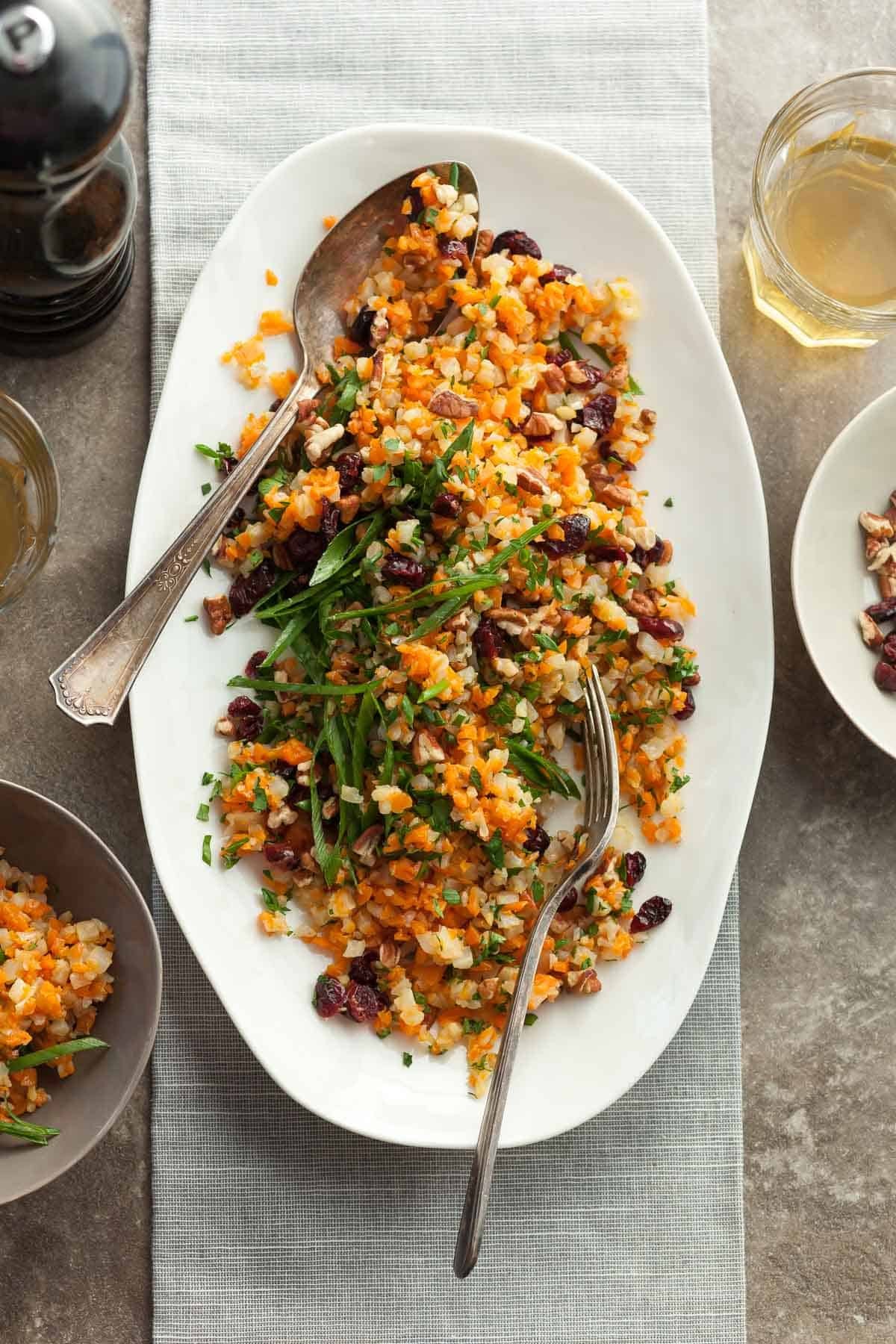 Vibrant cauliflower rice pilaf with fresh green herbs in a bowl, healthy meal