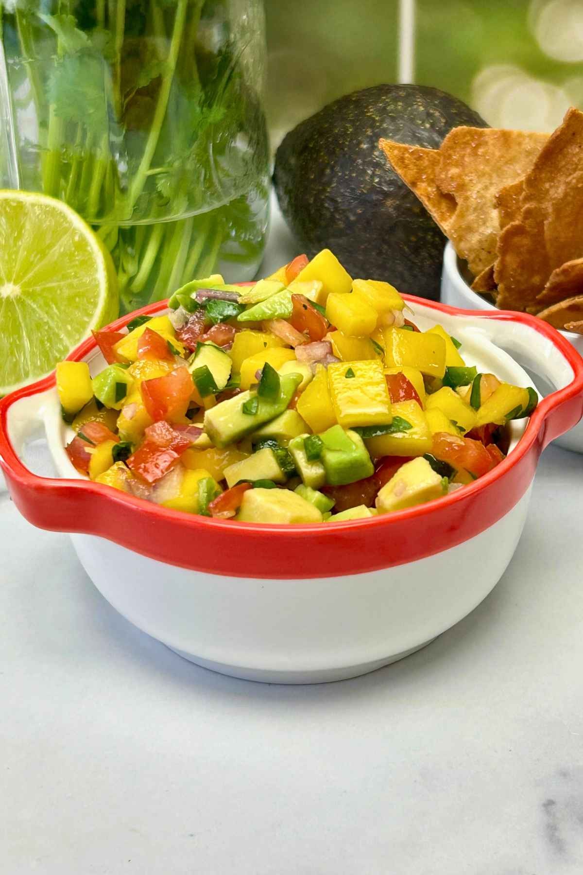 vibrant mango salsa with avocado and lime, served in a bowl