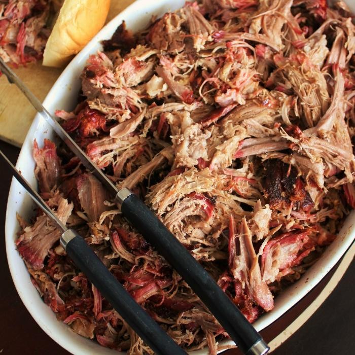 cider-brined pulled pork with apple chutney on a rustic wooden table