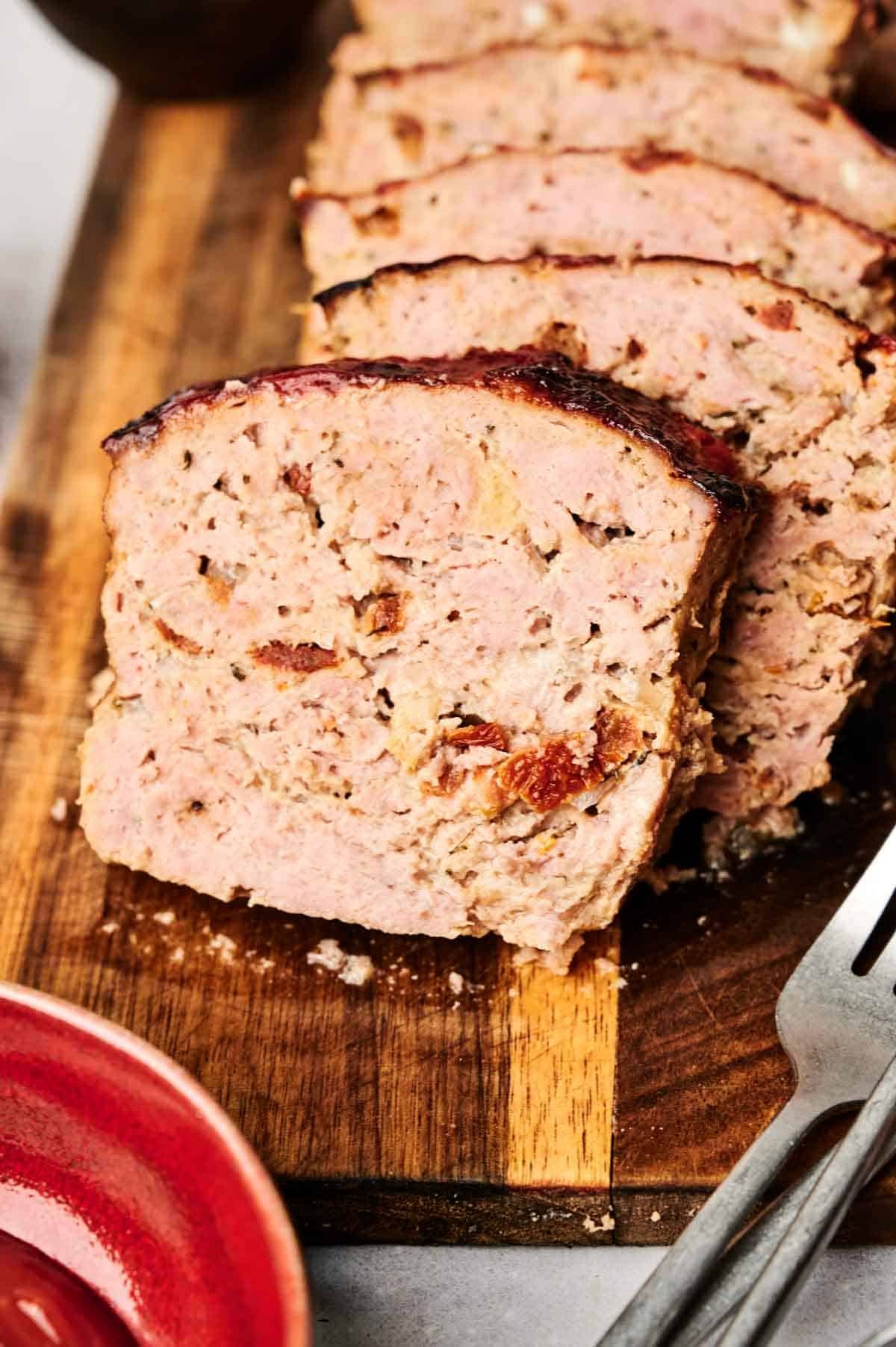 homemade juicy meatloaf on a wooden cutting board