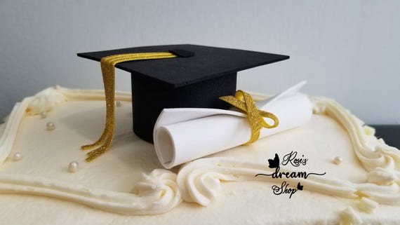 decorated graduation cake with diploma and graduation cap toppers