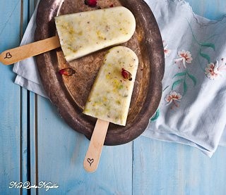 homemade pistachio rosewater popsicles on a wooden board