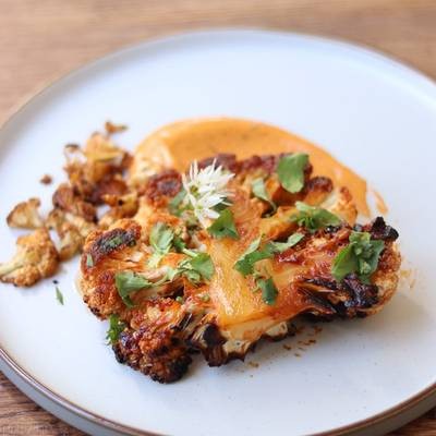 Gochujang glazed cauliflower steaks on a baking sheet