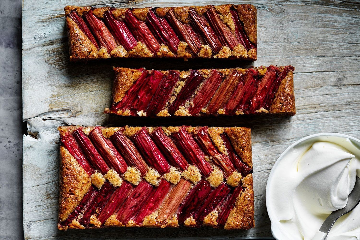 Rhubarb and macadamia cake on a wooden table