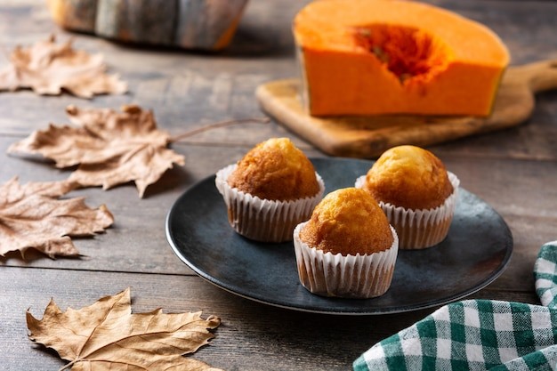 freshly baked pumpkin muffins on a wooden table