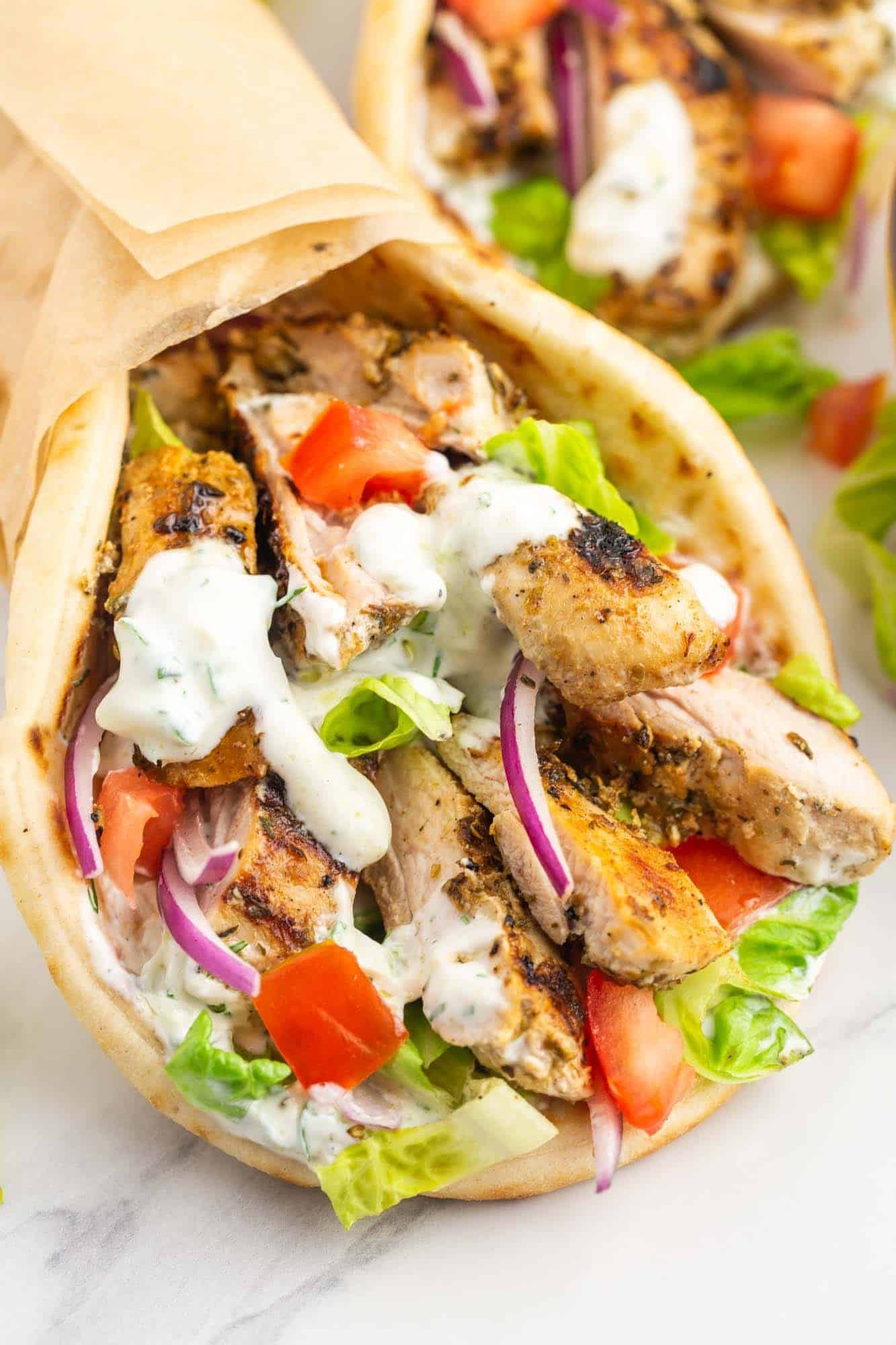 close up shot of chicken gyro bowl with tzatziki sauce
