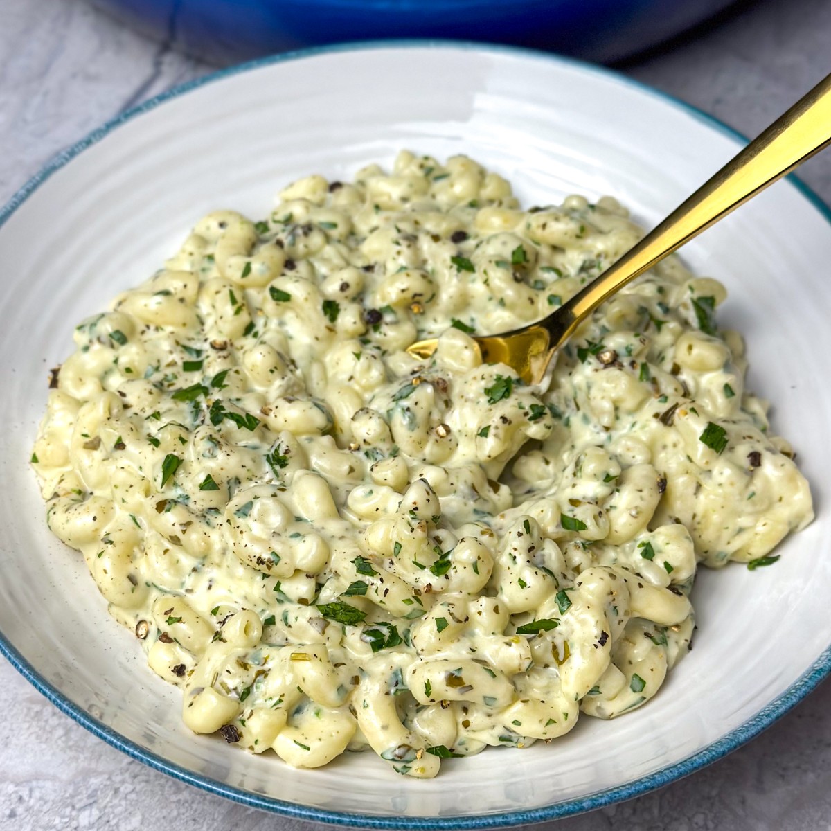creamy pesto parmesan mac and cheese in baking dish