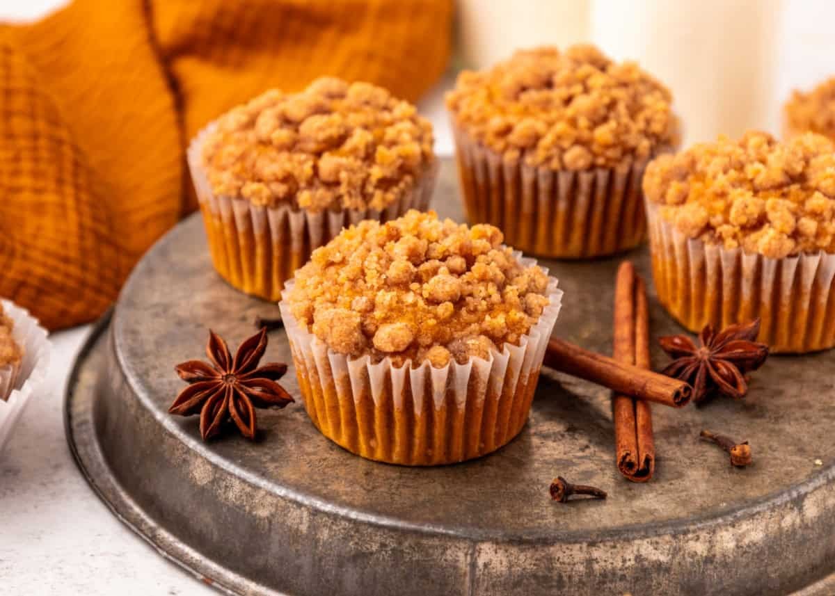 freshly baked pumpkin streusel muffins on a wooden table