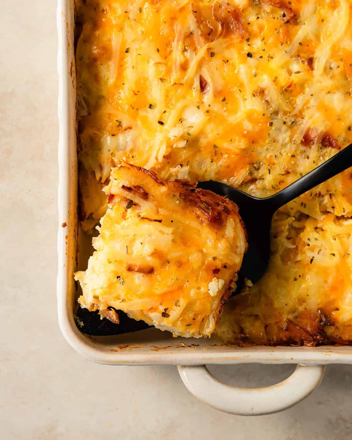 savory overnight breakfast casserole, golden brown, with fresh herbs on top, cozy kitchen setting