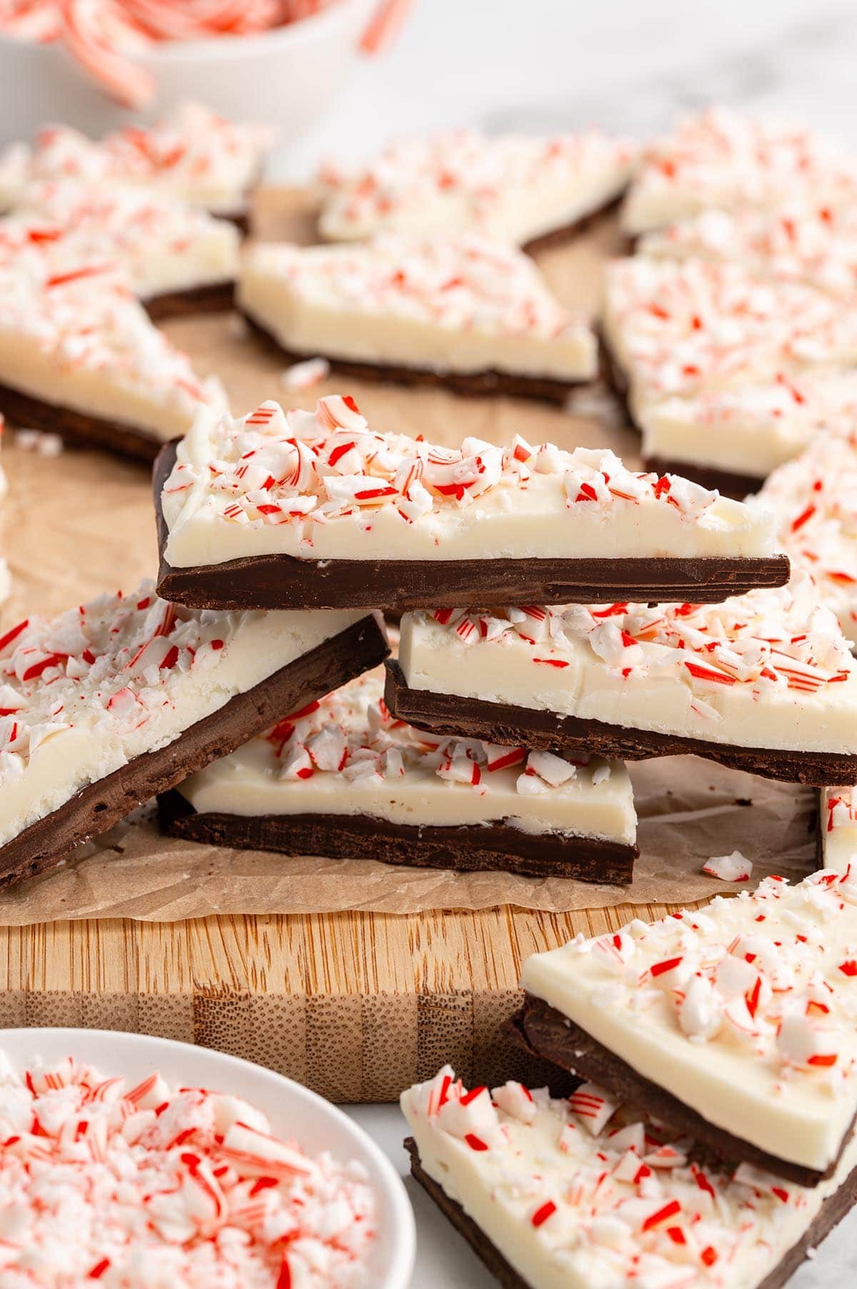 festive homemade peppermint bark with crushed candy canes on a wooden board