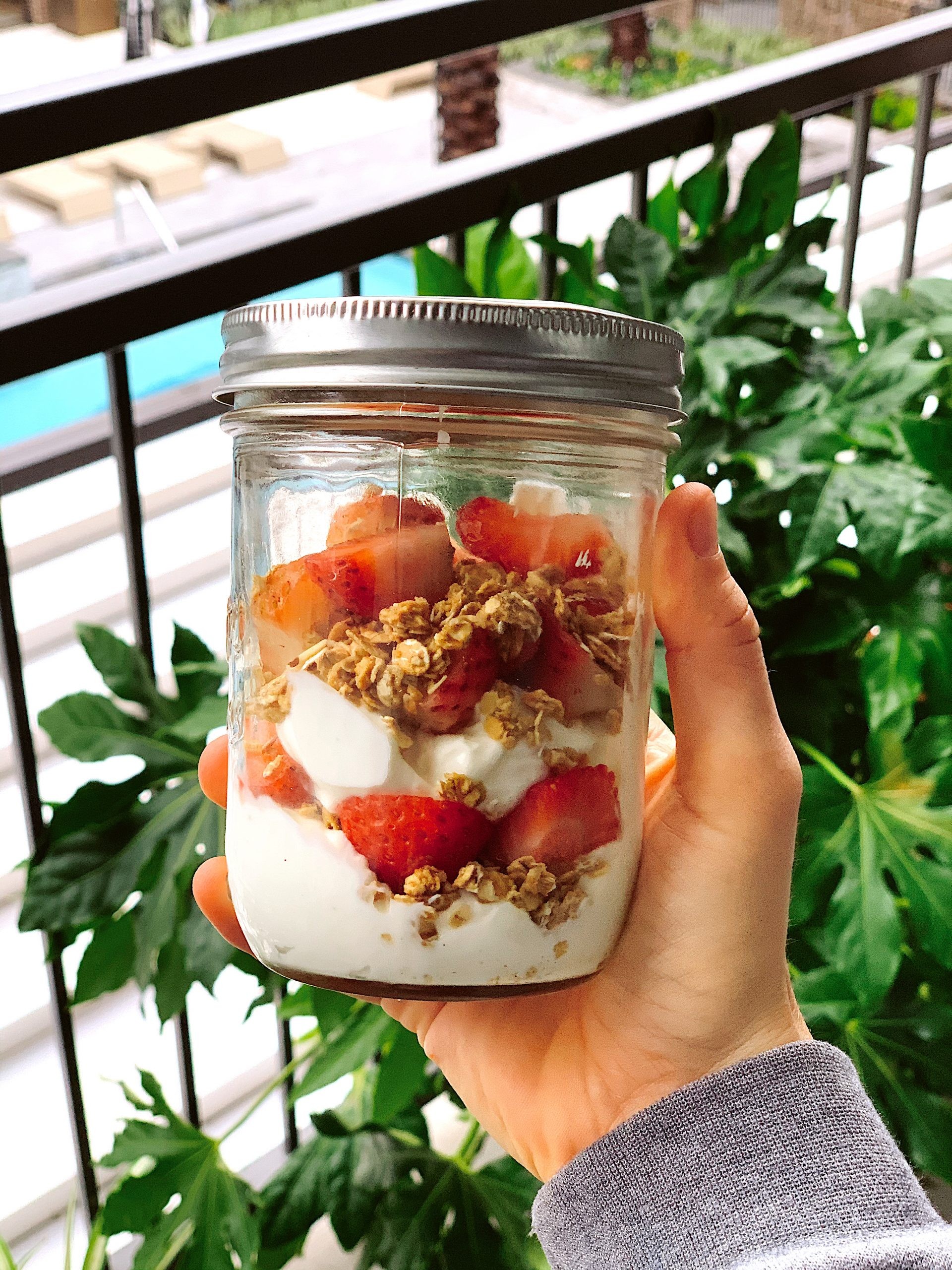 layered kumquat yogurt parfait in a glass jar