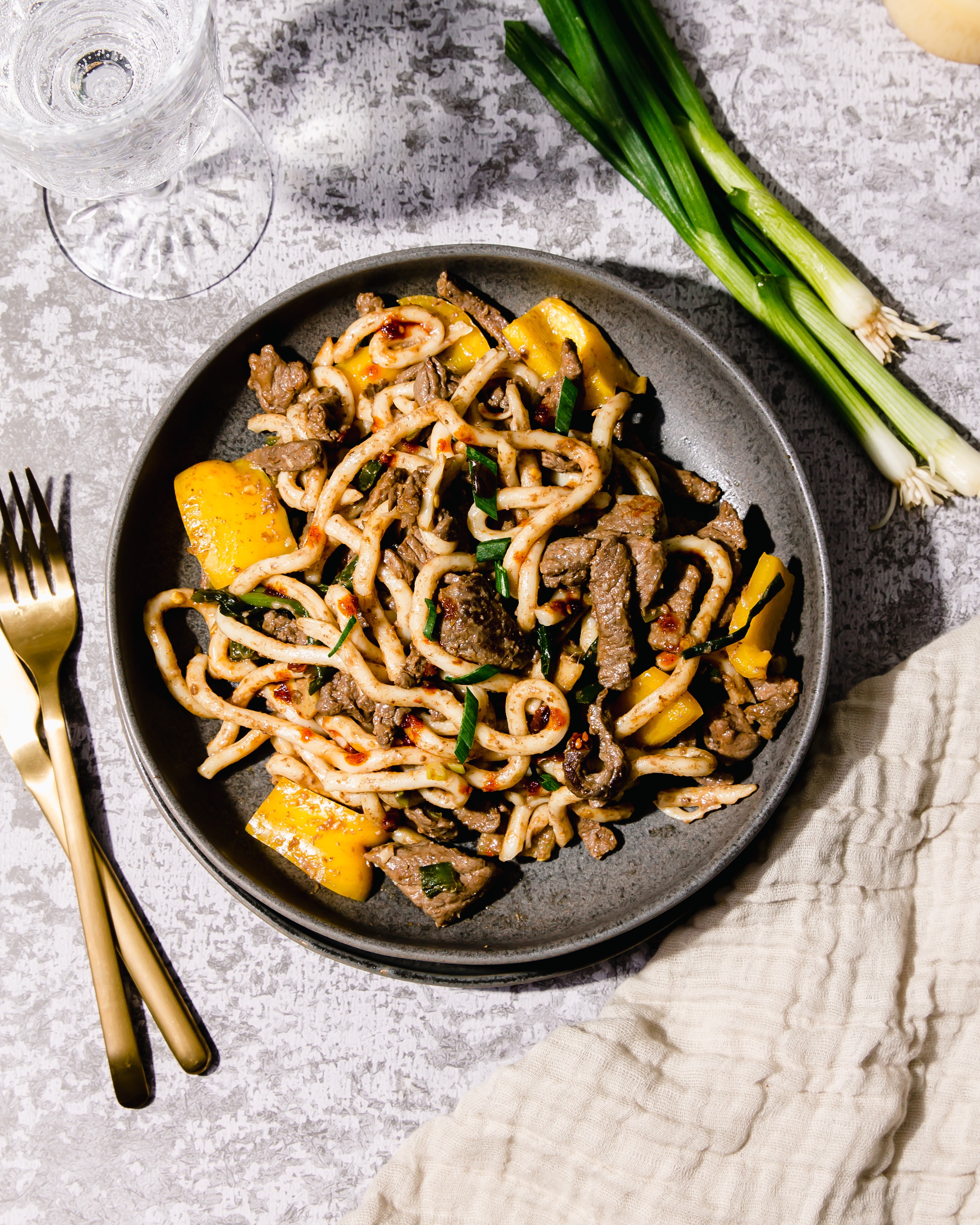 ginger scallion beef stir-fry noodles served in a bowl